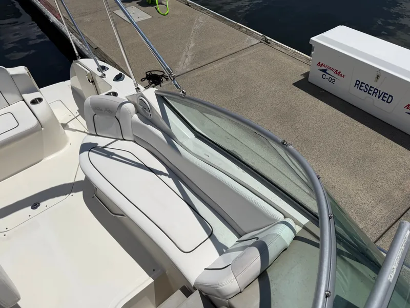 Slide: The Image of 2011 Sea Ray 240 Sundancer at dock, white upholstery. - 19