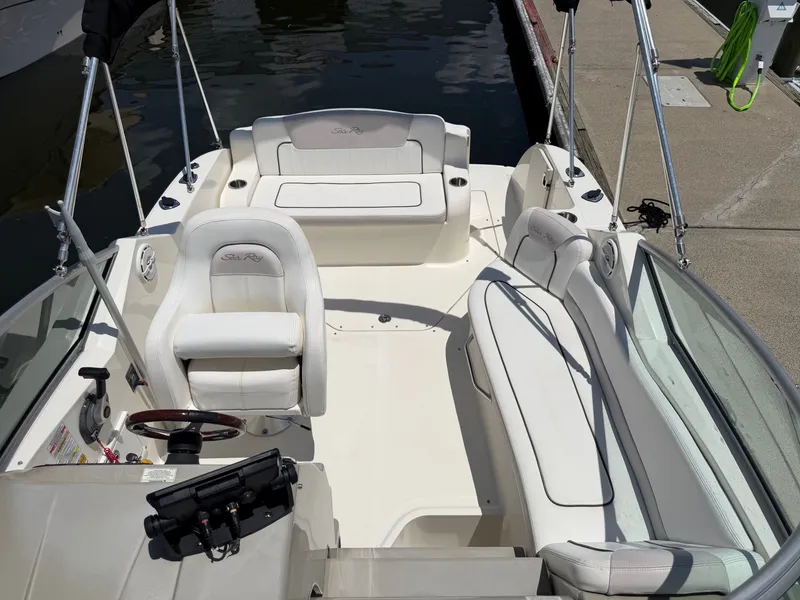 Slide: The Image of Interior of a 2011 Sea Ray 240 Sundancer with white seating. - 20