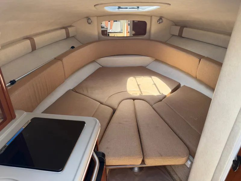 Slide: The Image of Interior of 2011 Sea Ray 240 Sundancer with cozy sleeping cabin. - 24