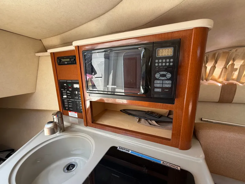 Slide: The Image of Interior of 2011 Sea Ray 240 Sundancer with microwave and sink. - 26