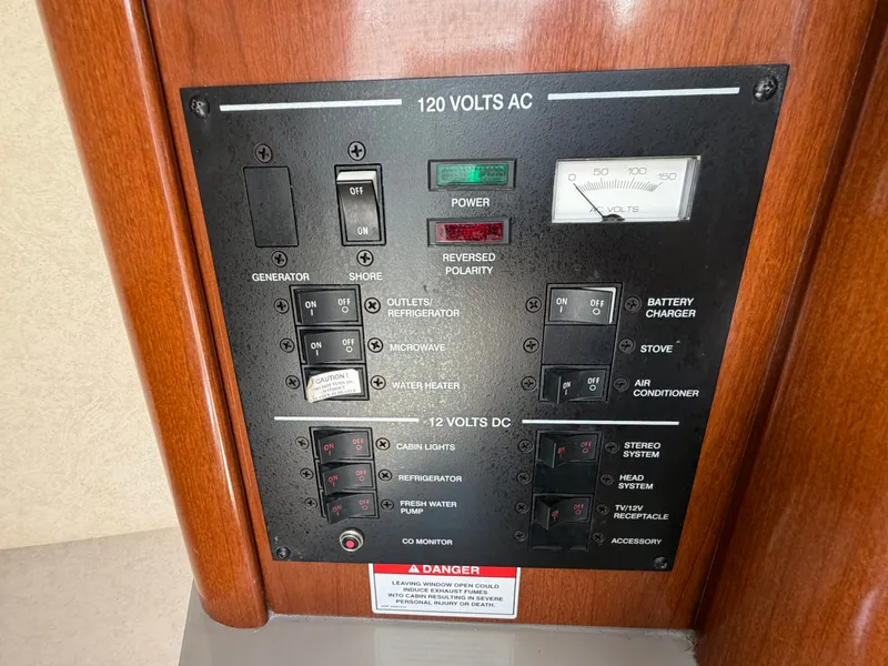 Slide: The Image of Electrical control panel of 2011 Sea Ray 240 Sundancer, 120 volts AC/DC. - 27