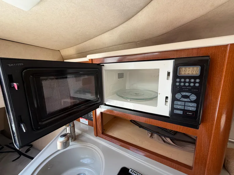 Slide: The Image of Microwave in the 2011 Sea Ray 240 Sundancer kitchen. - 29