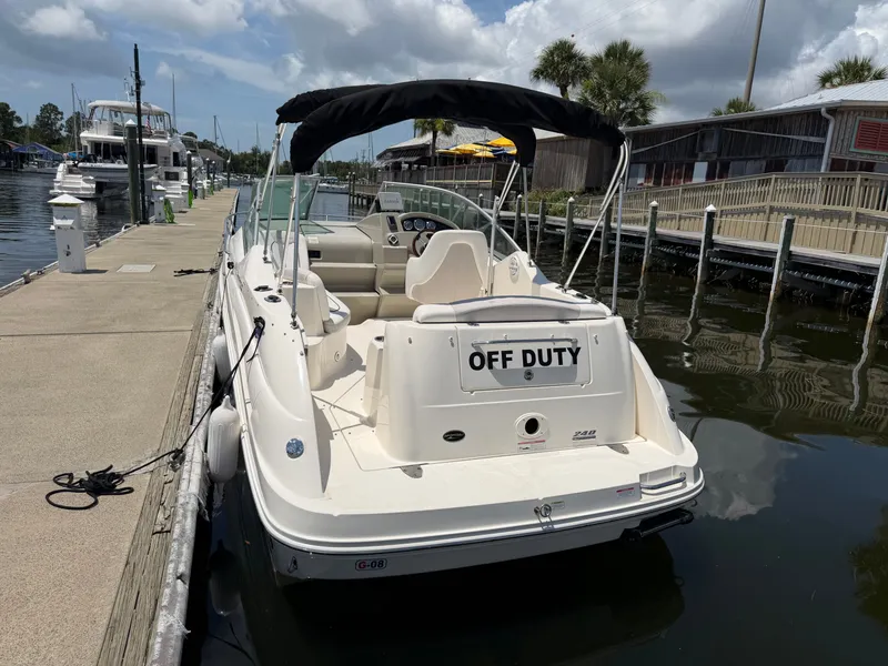 Slide: The Image of 2011 Sea Ray 240 Sundancer docked, featuring "Off Duty" sign. - 3