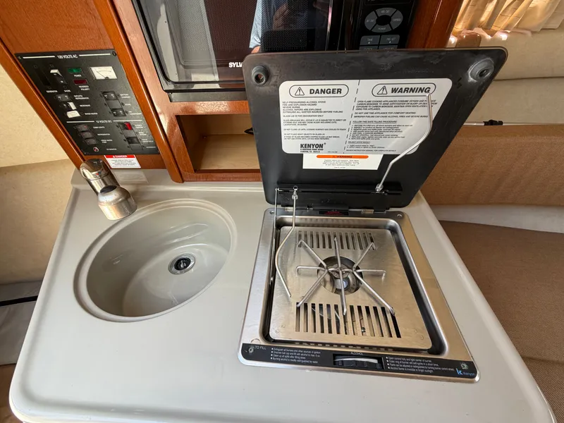 Slide: The Image of Sea Ray 240 Sundancer 2011 kitchen area with sink and stove. - 30