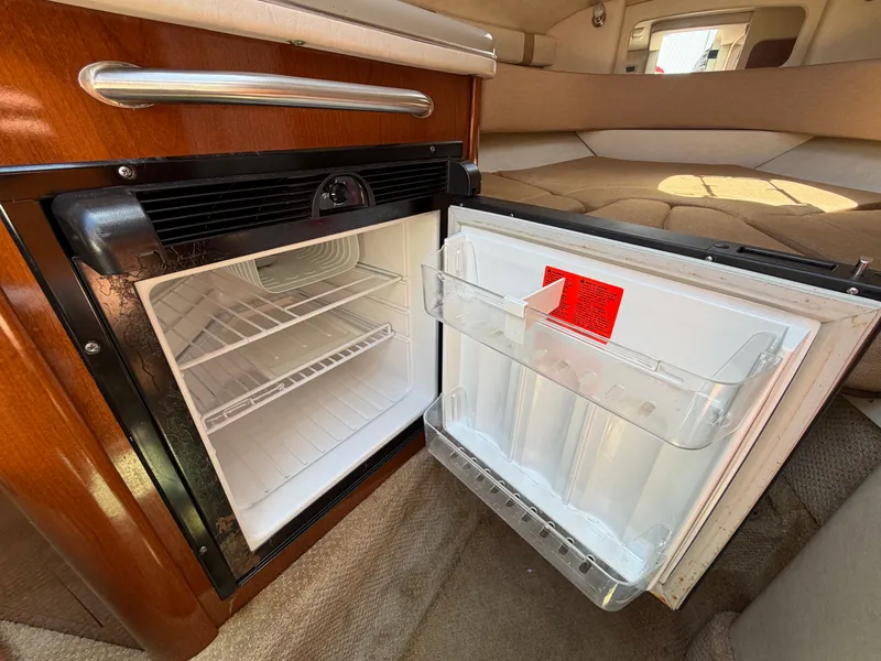 Slide: The Image of Open fridge in a 2011 Sea Ray 240 Sundancer yacht. - 31