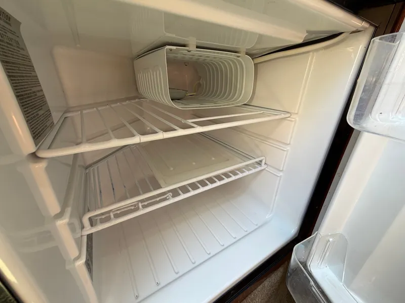 Slide: The Image of Empty fridge in 2011 Sea Ray 240 Sundancer boat. - 32