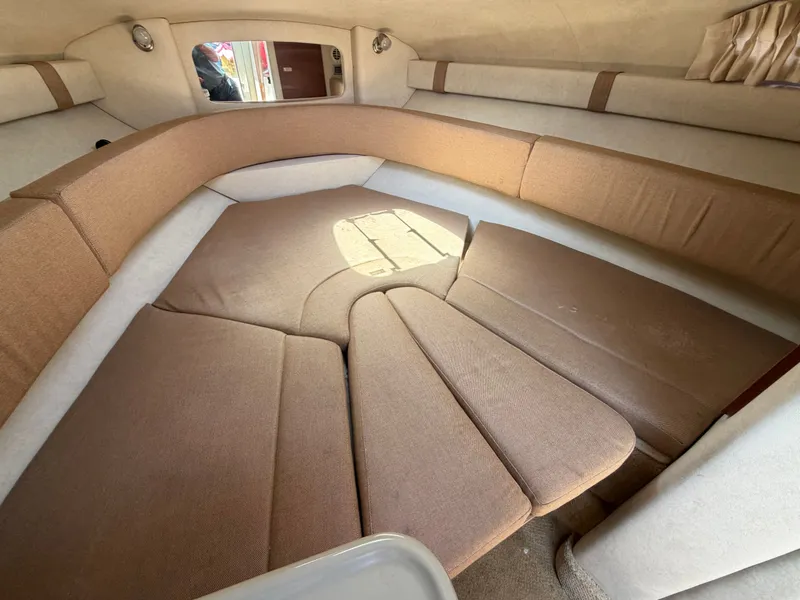 Slide: The Image of Interior of 2011 Sea Ray 240 Sundancer with beige upholstery. - 33