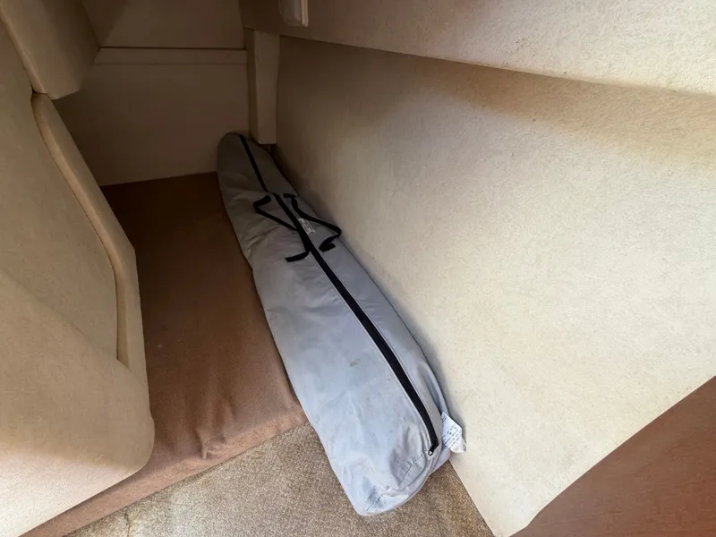 Slide: The Image of Interior of 2011 Sea Ray 240 Sundancer with luggage. - 36