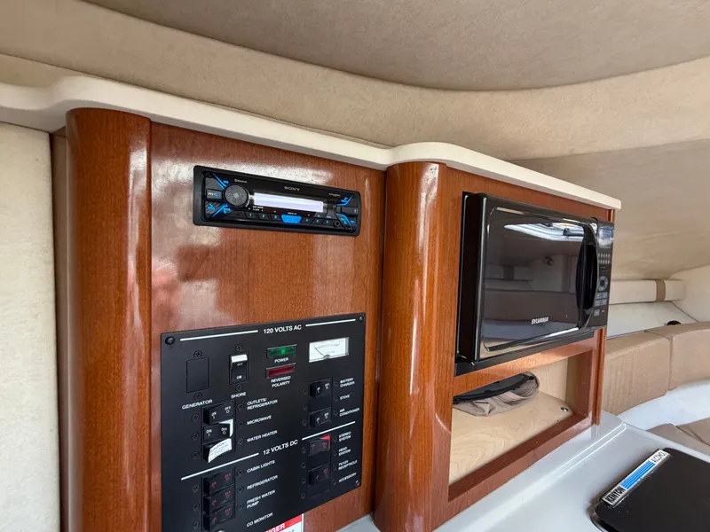 Slide: The Image of Interior of 2011 Sea Ray 240 Sundancer with microwave and control panel. - 39