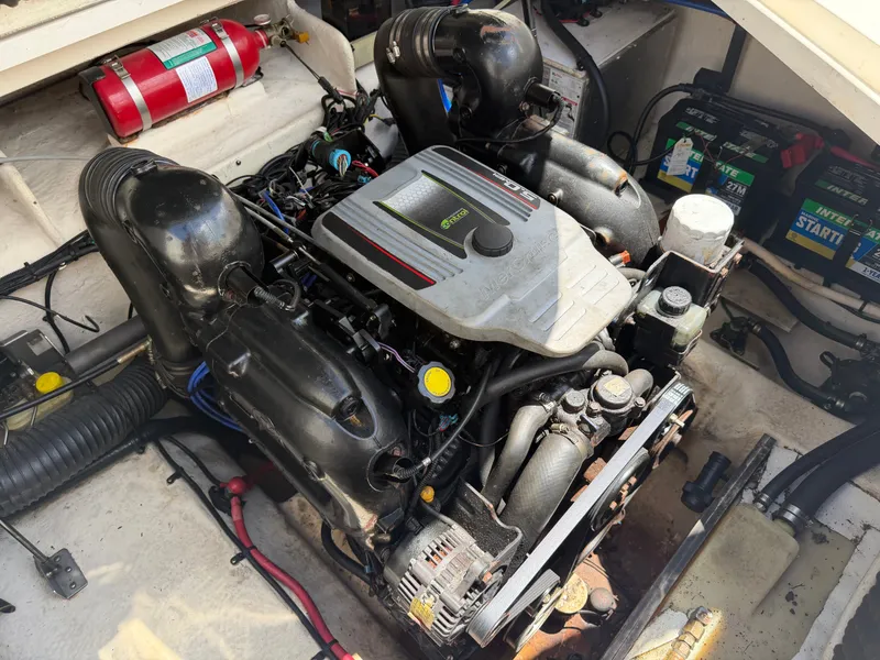 Slide: The Image of Engine compartment of a 2011 Sea Ray 240 Sundancer boat with engine and batteries. - 46