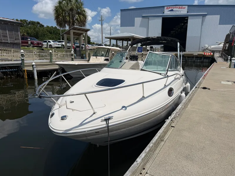 Slide: The Image of 2011 Sea Ray 240 Sundancer docked in sunny marina setting. - 5