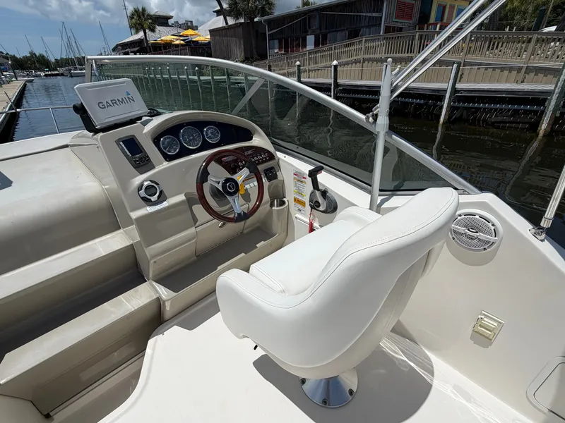 Slide: The Image of Interior of a 2011 Sea Ray 240 Sundancer with helm console. - 8