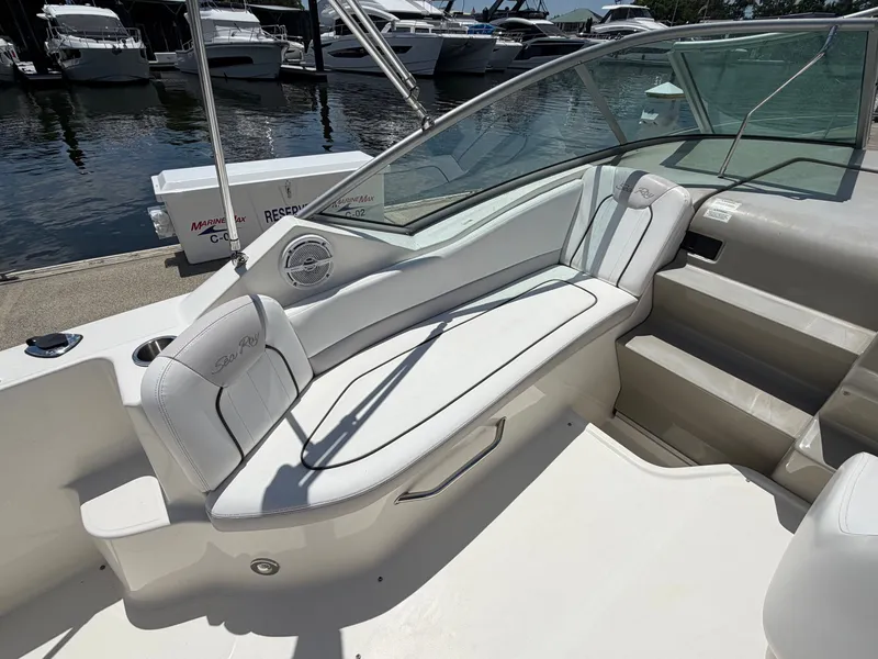 Slide: The Image of Interior of a 2011 Sea Ray 240 Sundancer with white seating. - 9