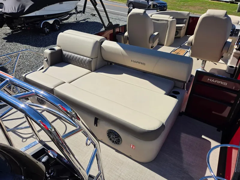 Slide: The Image of The image shows the interior of a 2027 Harris Cruiser 210 boat with beige seating. - 7