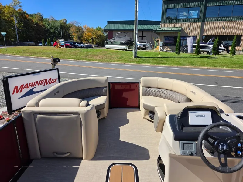 Slide: The Image of 2027 Harris Cruiser 210 with beige seating and a modern helm station. - 16