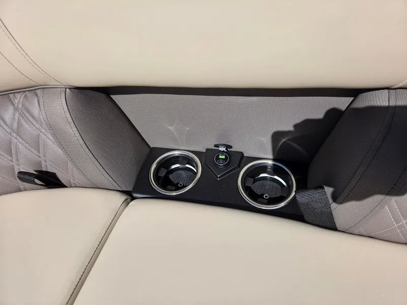 Slide: The Image of Beige upholstery with two cup holders and a USB port in the center. - 19