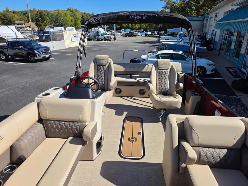 Slide: The Image of 2027 Harris Cruiser 210 with luxurious seating and modern design, parked in a lot. - 11
