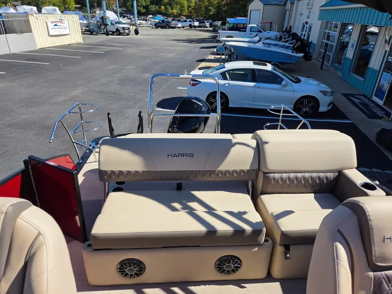 Slide: The Image of The image shows the deck of a 2027 Harris Cruiser 210 with beige seating and speakers. - 10