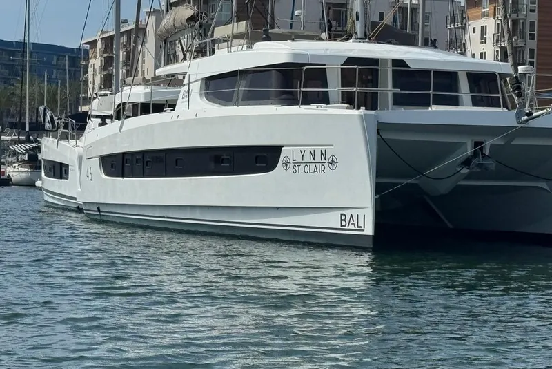 Slide: The Image of 2023 Bali 4.6 catamaran docked in marina, featuring sleek design and modern architecture. - 1