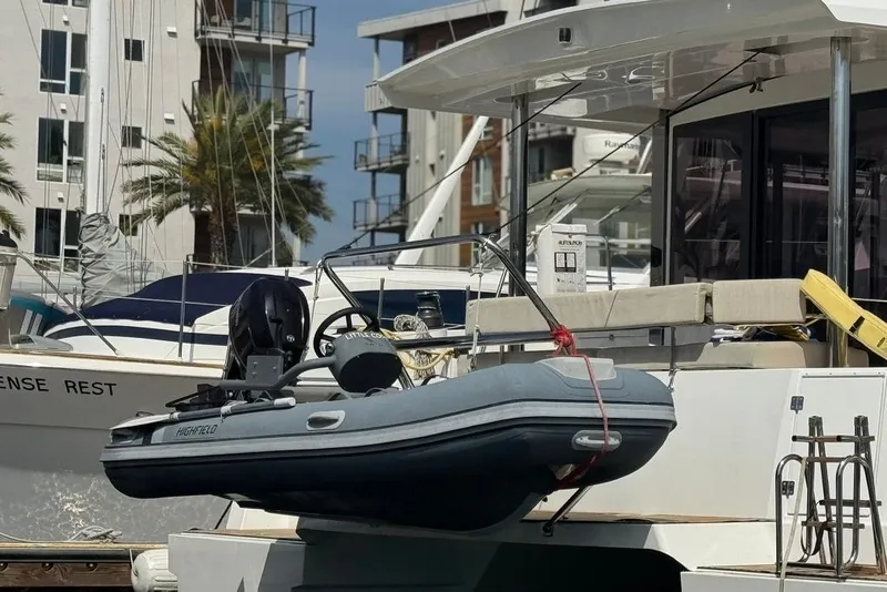 Slide: The Image of 2023 Bali 4.6 yacht with inflatable boat docked in marina. - 12