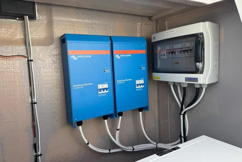Slide: The Image of Electrical setup with Victron Energy autotransformers and circuit breaker on a Bali 4.6, 2023 model. - 27