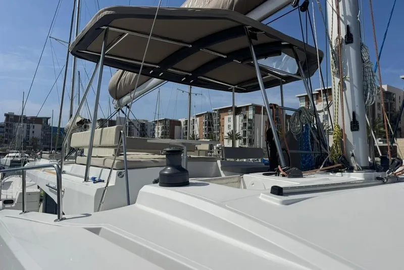 Slide: The Image of 2023 Bali 4.6 yacht docked at marina with modern buildings in background. - 29