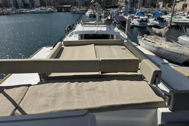 Slide: The Image of Luxurious 2023 Bali 4.6 yacht with spacious sunbathing deck in a marina setting. - 30