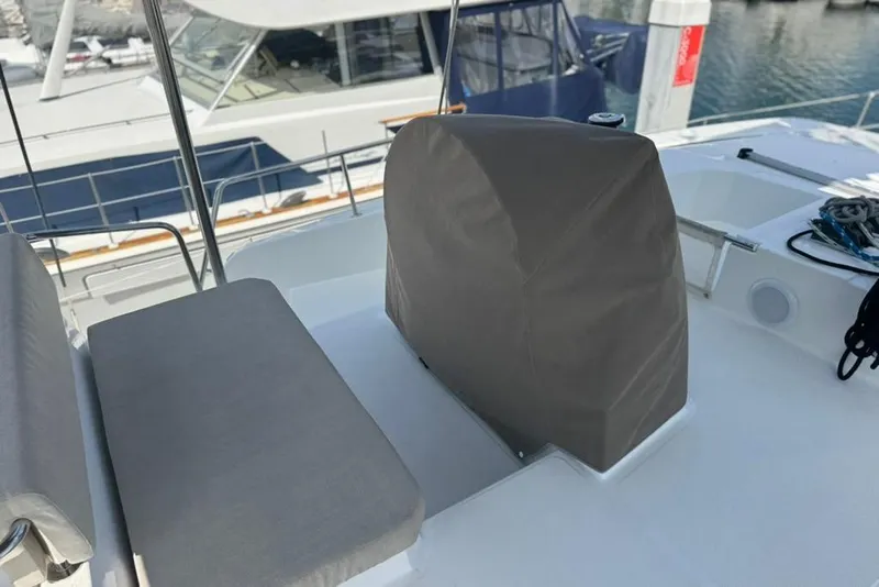 Slide: The Image of Covered helm station on a 2023 Bali 4.6 catamaran, docked at a marina. - 31
