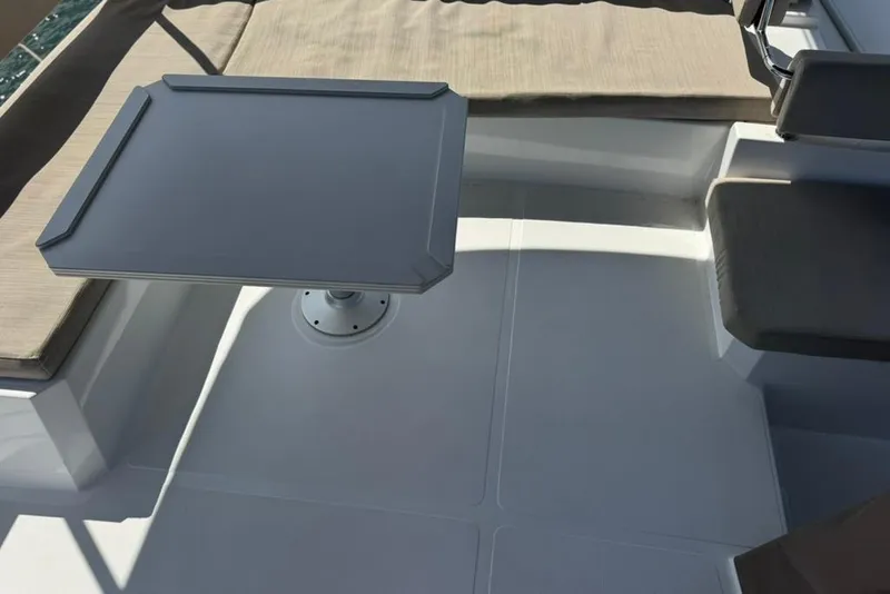 Slide: The Image of Modern Bali 4.6 yacht interior with table and cushioned seating, 2023 model. - 36