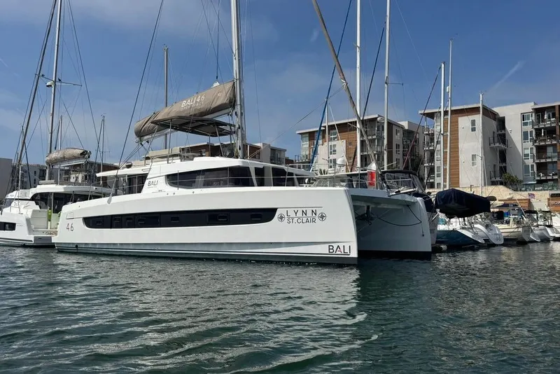 Slide: The Image of Modern 2023 Bali 4.6 catamaran docked in a marina, surrounded by other boats. - 4