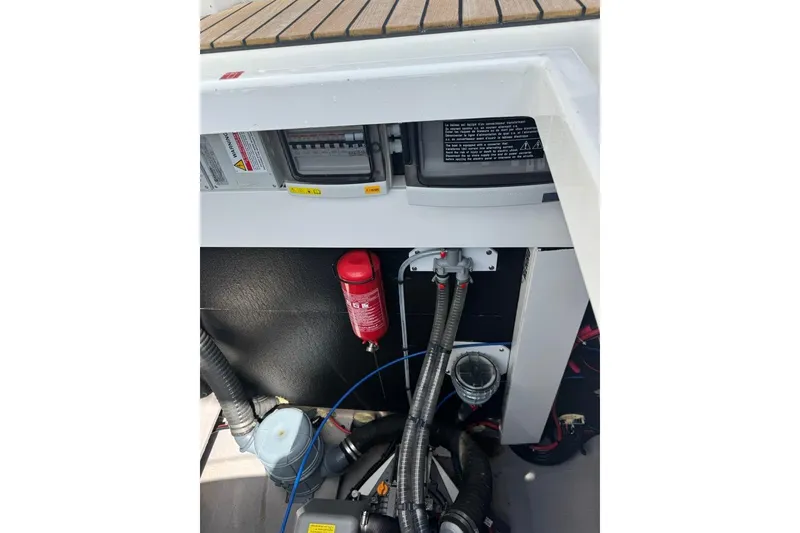 Slide: The Image of Engine compartment of a 2023 Bali 4.6 yacht, featuring wiring and safety equipment. - 43