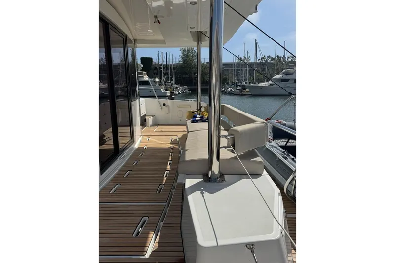 Slide: The Image of 2023 Bali 4.6 yacht deck with seating, docked at marina. - 45