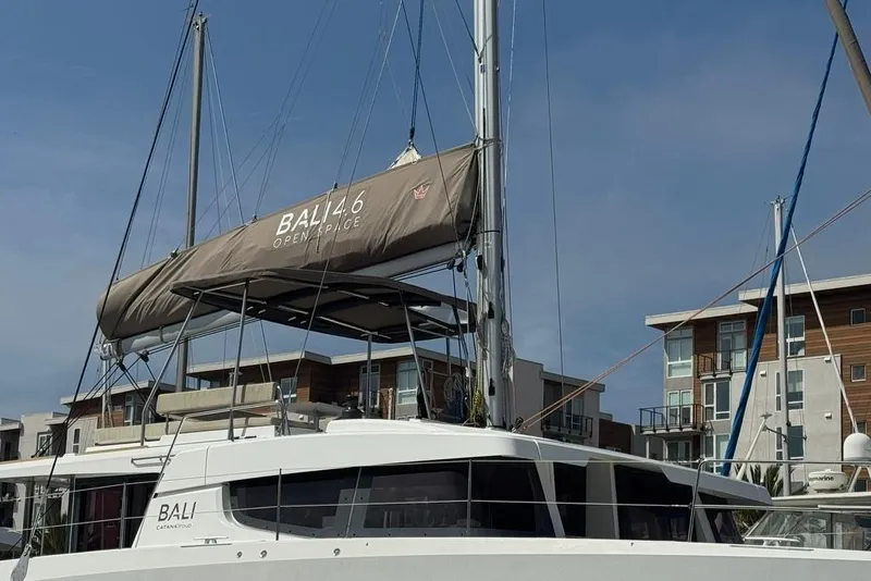 Slide: The Image of 2023 Bali 4.6 catamaran docked near modern buildings under clear sky. - 5