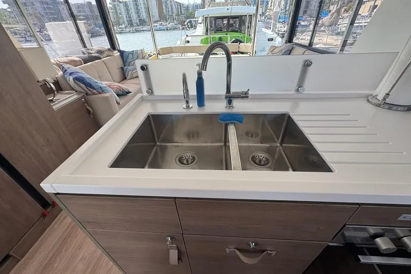 Slide: The Image of Modern kitchen sink on a 2023 Bali 4.6 yacht, overlooking marina views. - 60