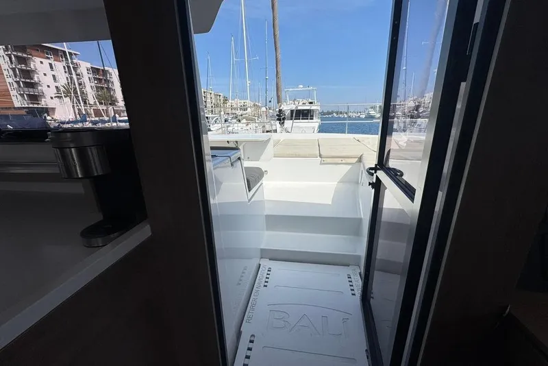 Slide: The Image of View from inside a 2023 Bali 4.6 yacht, overlooking a marina with boats. - 63