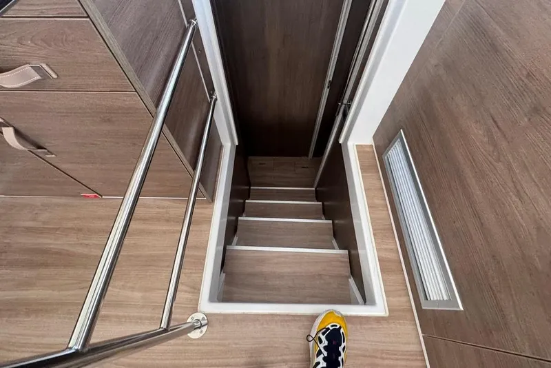 Slide: The Image of Staircase inside 2023 Bali 4.6 model, featuring wooden steps and metal railing. - 64