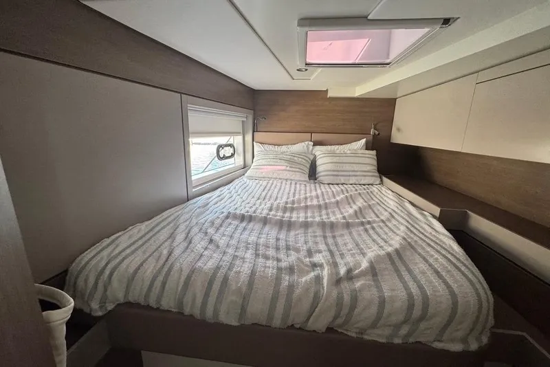 Slide: The Image of Luxurious bedroom interior of 2023 Bali 4.6 yacht with striped bedding and window view. - 65