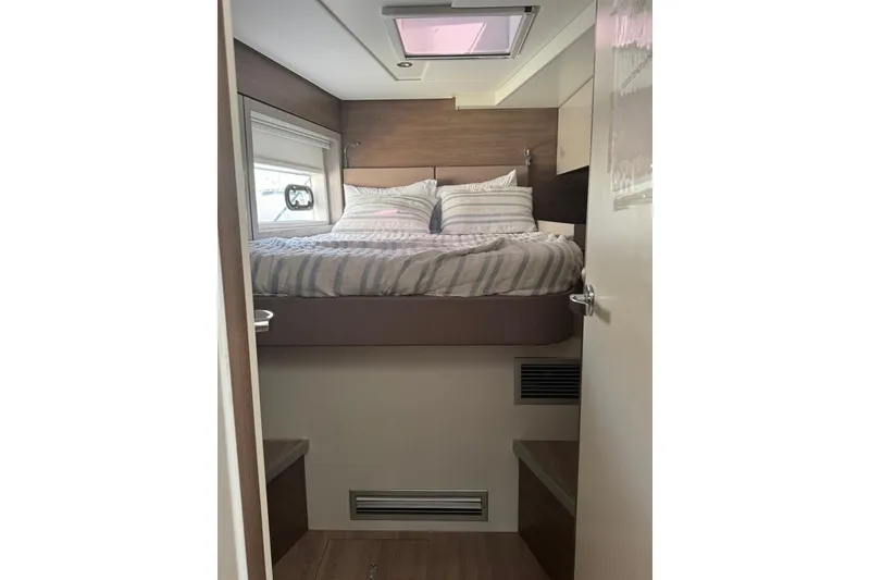 Slide: The Image of Cozy bedroom interior in 2023 Bali 4.6 yacht with striped bedding and skylight. - 70