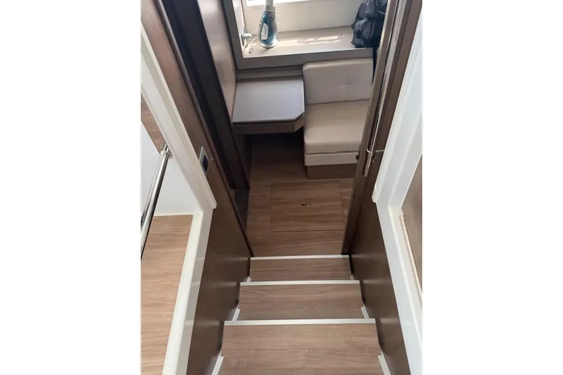Slide: The Image of Interior view of 2023 Bali 4.6 yacht, featuring wooden stairs and cozy seating area. - 72