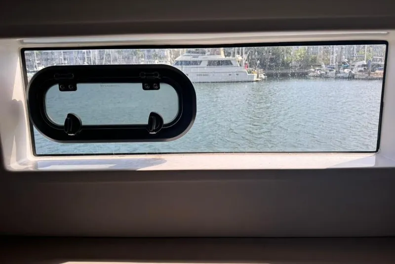 Slide: The Image of Window view from 2023 Bali 4.6 yacht, overlooking marina with boats. - 79