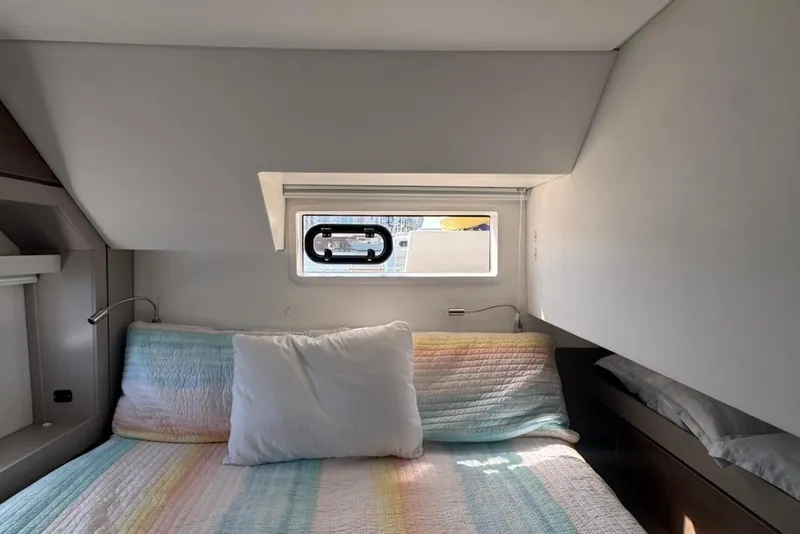 Slide: The Image of Cozy cabin interior of 2023 Bali 4.6 yacht with colorful bedding and window. - 86