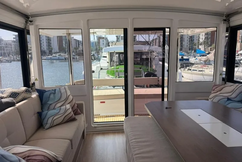 Slide: The Image of Interior view of 2023 Bali 4.6 yacht, featuring cozy seating and marina backdrop. - 91