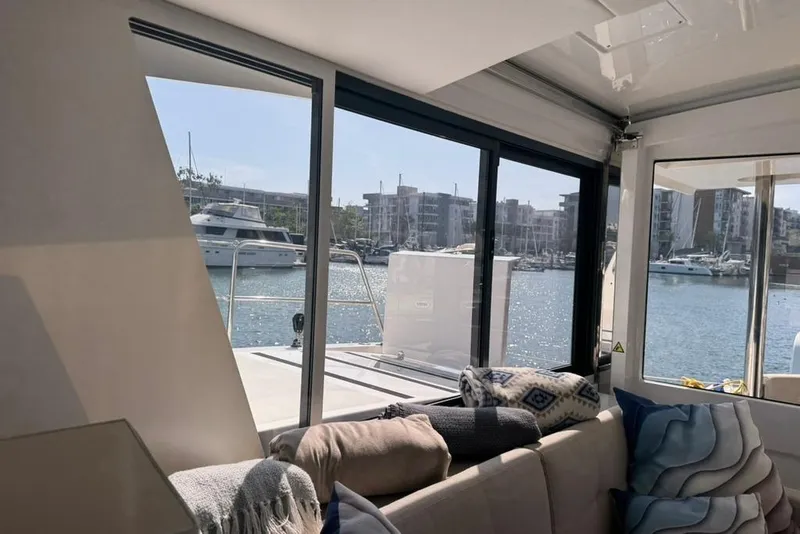 Slide: The Image of Interior view of 2023 Bali 4.6 yacht, showcasing marina through large windows. - 93