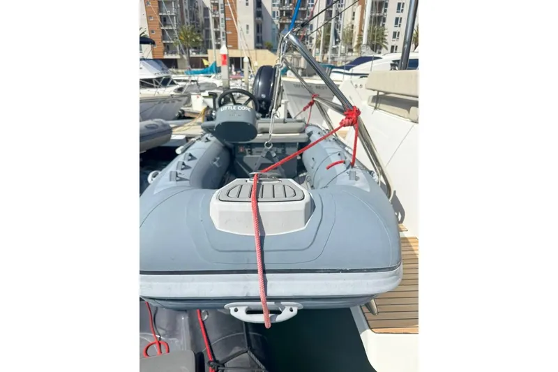 Slide: The Image of 2023 Bali 4.6 inflatable boat docked at marina, secured with red ropes. - 94