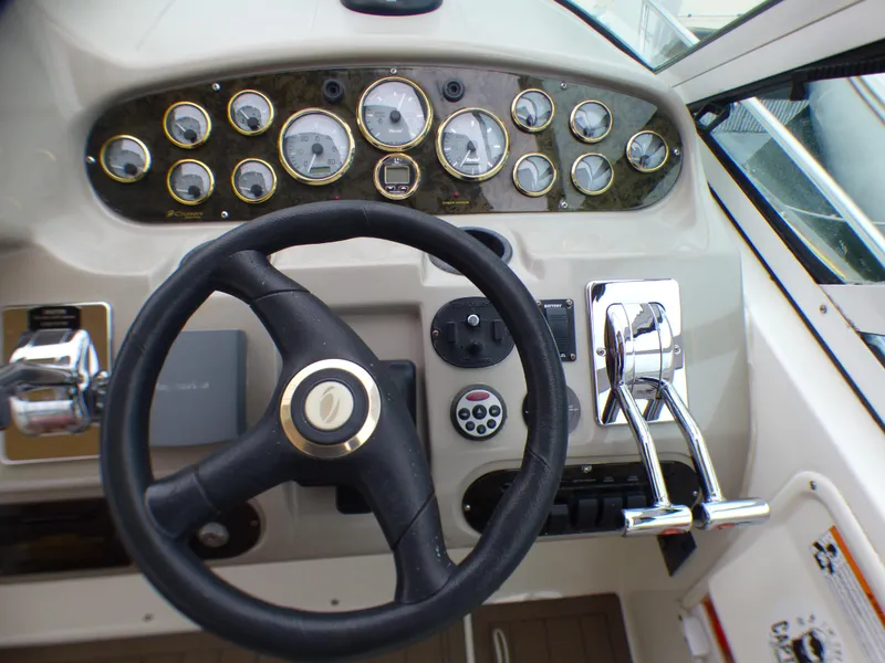 Slide: The Image of 2001 Cruisers Yachts 340 Express helm with gauges and steering wheel. - 12