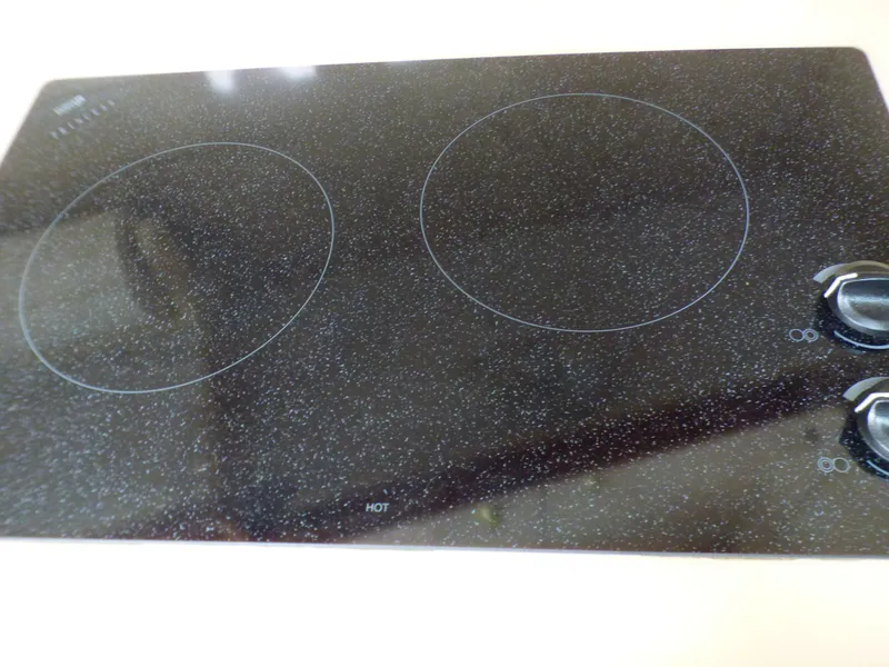 Slide: The Image of Glass ceramic cooktop with two burners and control knobs. - 19