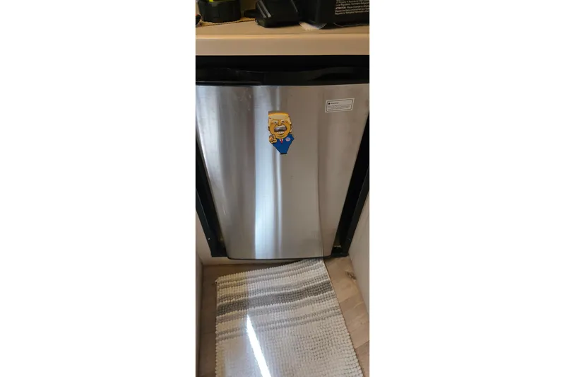 Slide: The Image of Stainless steel fridge with cartoon magnet inside 2001 Cruisers Yachts 340 Express. - 21