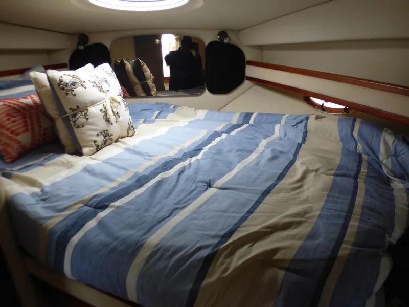 Slide: The Image of Cruisers Yachts 340 Express 2001 cabin with striped bedding. - 24