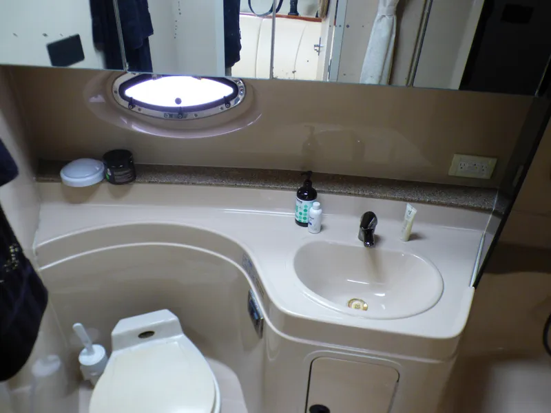 Slide: The Image of 2001 Cruisers Yachts 340 Express bathroom with sink and toilet. - 26