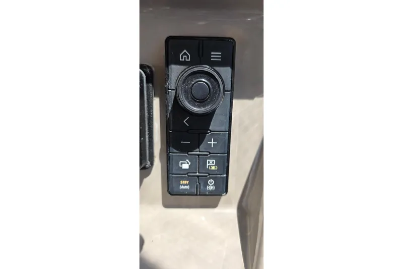 Slide: The Image of Control panel of a 2001 Cruisers Yachts 340 Express, featuring navigation and function buttons. - 33
